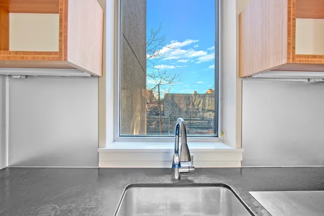 a kitchen with a refrigerator and a sink