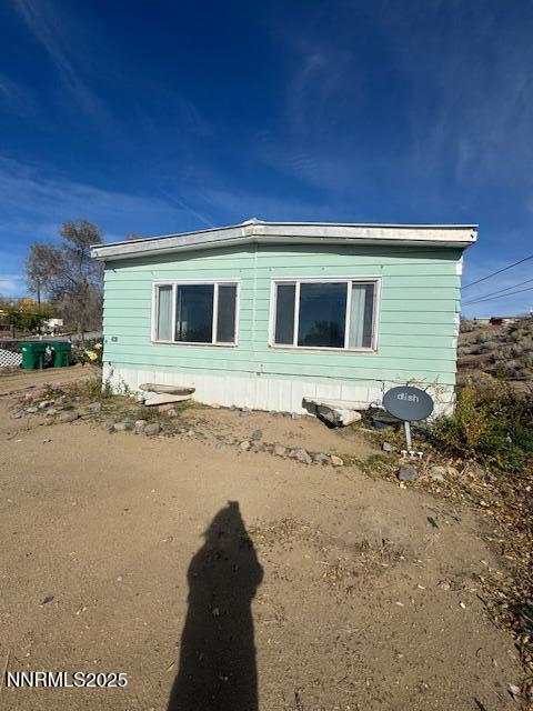 241 Harmony Lane Sun Valley, NV 89433 - Photo 22 of 29 a front view of a house with a yard