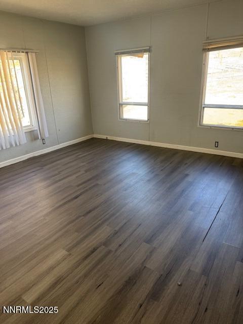 241 Harmony Lane Sun Valley, NV 89433 - Photo 10 of 29 an empty room with wooden floor and windows