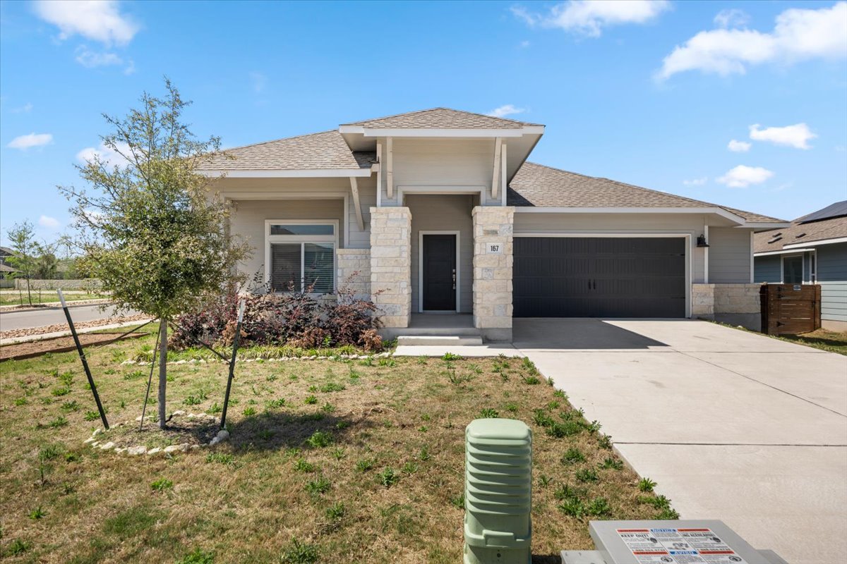 167 Jeffers Kyle, TX 78640 - Photo 34 of 40 Prairie-style house with a garage, stone siding, driveway, and a front yard