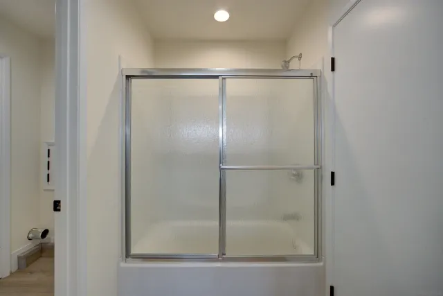 a bathroom with a glass shower door