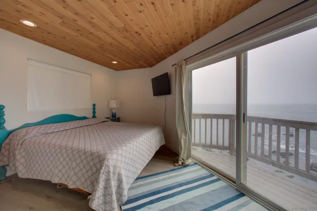 a bed sitting in a spacious bedroom next to a window