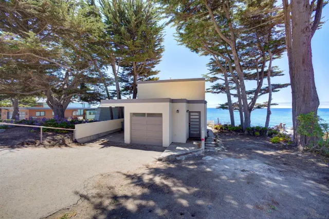 a view of a house with a yard covered with snow