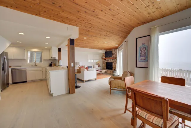 a living room with furniture and kitchen view