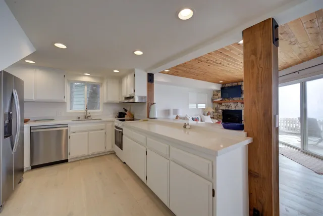 a large kitchen with kitchen island a sink a stove and a refrigerator