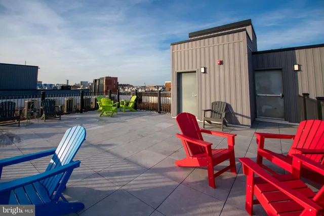 a living room with furniture a flat screen tv and a table