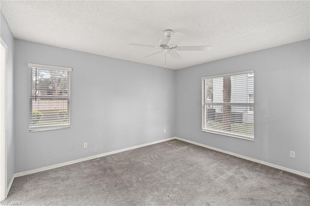 161 Wading Bird Circle, Unit L101 Naples, FL 34110 - Photo 13 of 35 a view of an empty room with a window