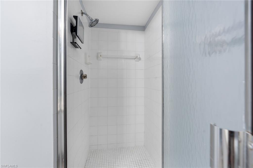 161 Wading Bird Circle, Unit L101 Naples, FL 34110 - Photo 16 of 35 a bathroom with a shower