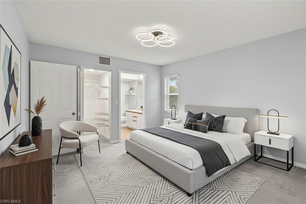 161 Wading Bird Circle, Unit L101 Naples, FL 34110 - Photo 17 of 44 Bedroom virtual staged with ensuite bathroom and light carpet