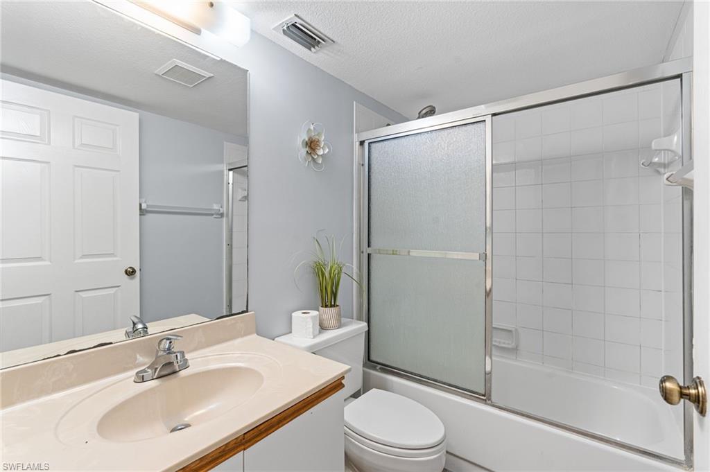 161 Wading Bird Circle, Unit L101 Naples, FL 34110 - Photo 18 of 35 a bathroom with a sink toilet and shower
