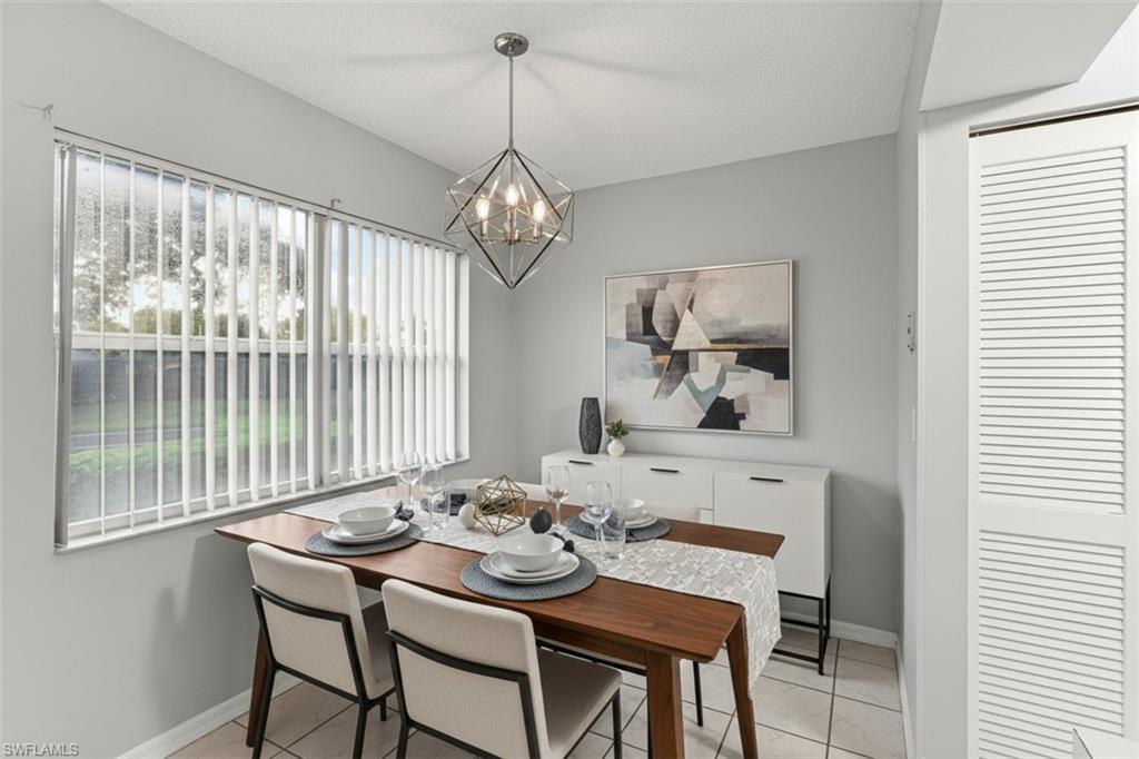 161 Wading Bird Circle, Unit L101 Naples, FL 34110 - Photo 2 of 44 Dining space virtual staged featuring suspended lighting and baseboards