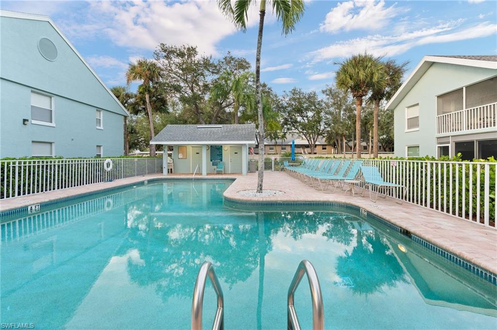 161 Wading Bird Circle, Unit L101 Naples, FL 34110 - Photo 26 of 35 a view of a house with a yard
