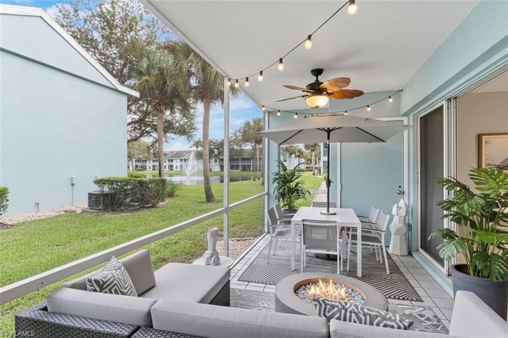 161 Wading Bird Circle, Unit L101 Naples, FL 34110 - Photo 30 of 44 Screened patio virtual staged featuring outdoor lounge area, ceiling fan, and a fire pit