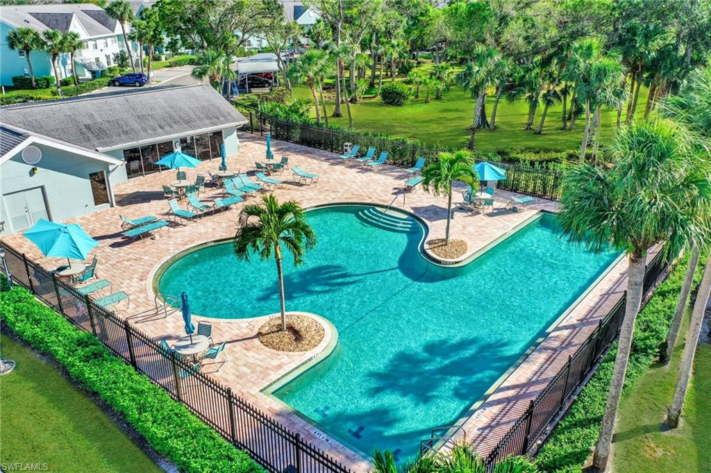 161 Wading Bird Circle, Unit L101 Naples, FL 34110 - Photo 39 of 44 Community pool with a patio area