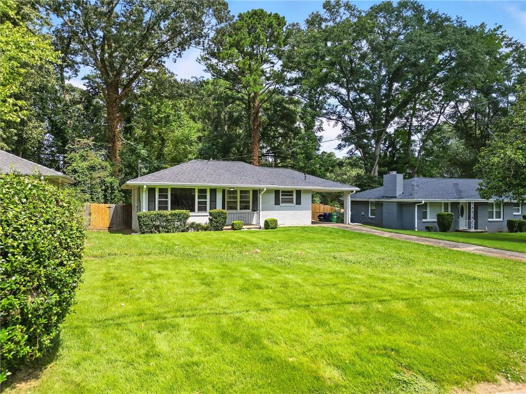 a front view of a house with a garden