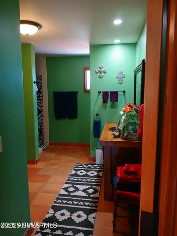 a view of a hallway with closet and a mirror
