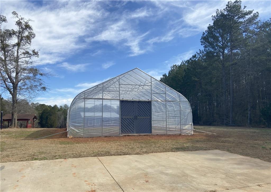 1599 Lower River Road Covington, GA 30016 - Photo 15 of 23 a front view of a house with a yard and garage