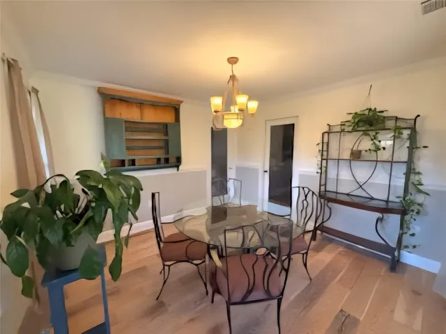 a dining room with furniture and wooden floor
