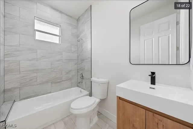 a bathroom with a sink a toilet and bathtub