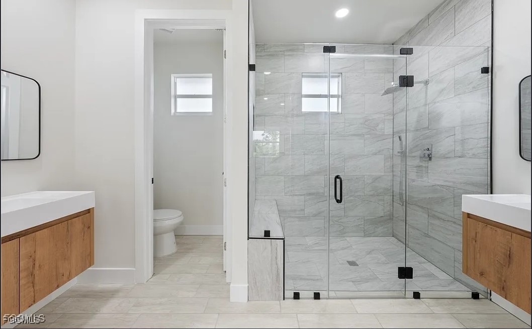2719 42nd Street West Lehigh Acres, FL 33971 - Photo 14 of 20 a bathroom with a shower a toilet and sink