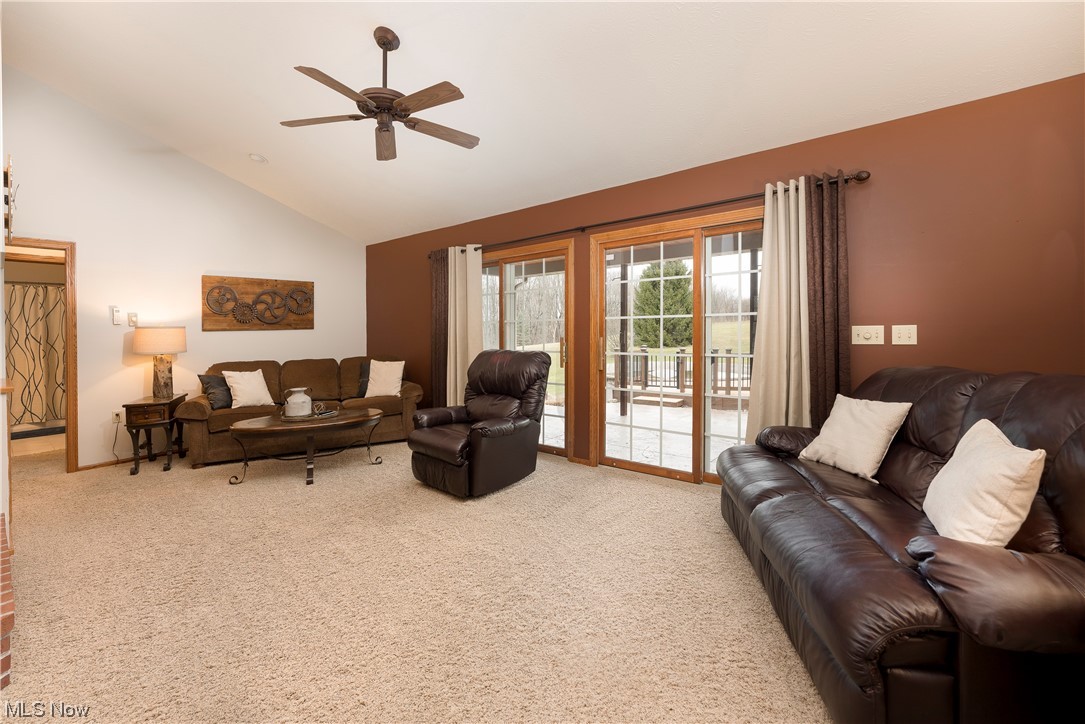 5659 State Rte 5 Ravenna, OH 44266 - Photo 4 of 48 Living room featuring light carpet, high vaulted ceiling, and ceiling fan