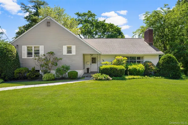 a view of a house with a yard and plants