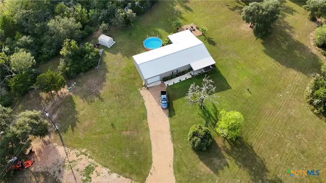 an aerial view of a house with a yard