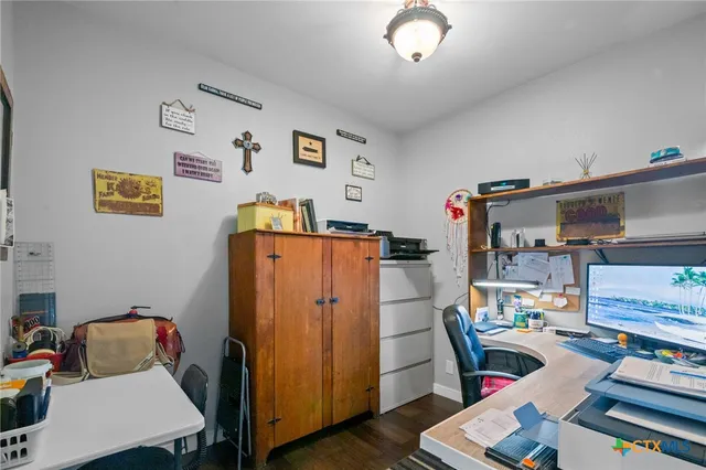 a work room with furniture and wooden floor