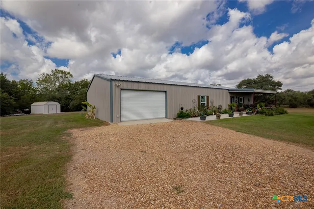 a front view of house with yard and trees