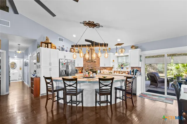 a kitchen with lots of counter top space and wooden floor