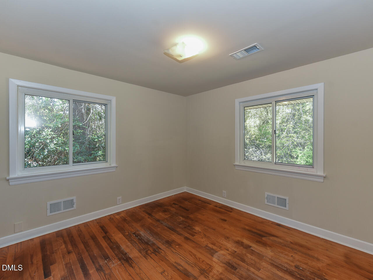 4916 Western Boulevard Raleigh, NC 27606 - Photo 15 of 18 a view of an empty room with wooden floor and a window