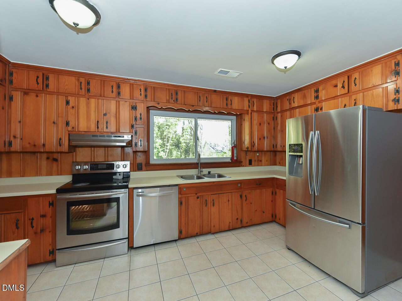 4916 Western Boulevard Raleigh, NC 27606 - Photo 6 of 18 a kitchen with stainless steel appliances granite countertop a stove a sink and a refrigerator
