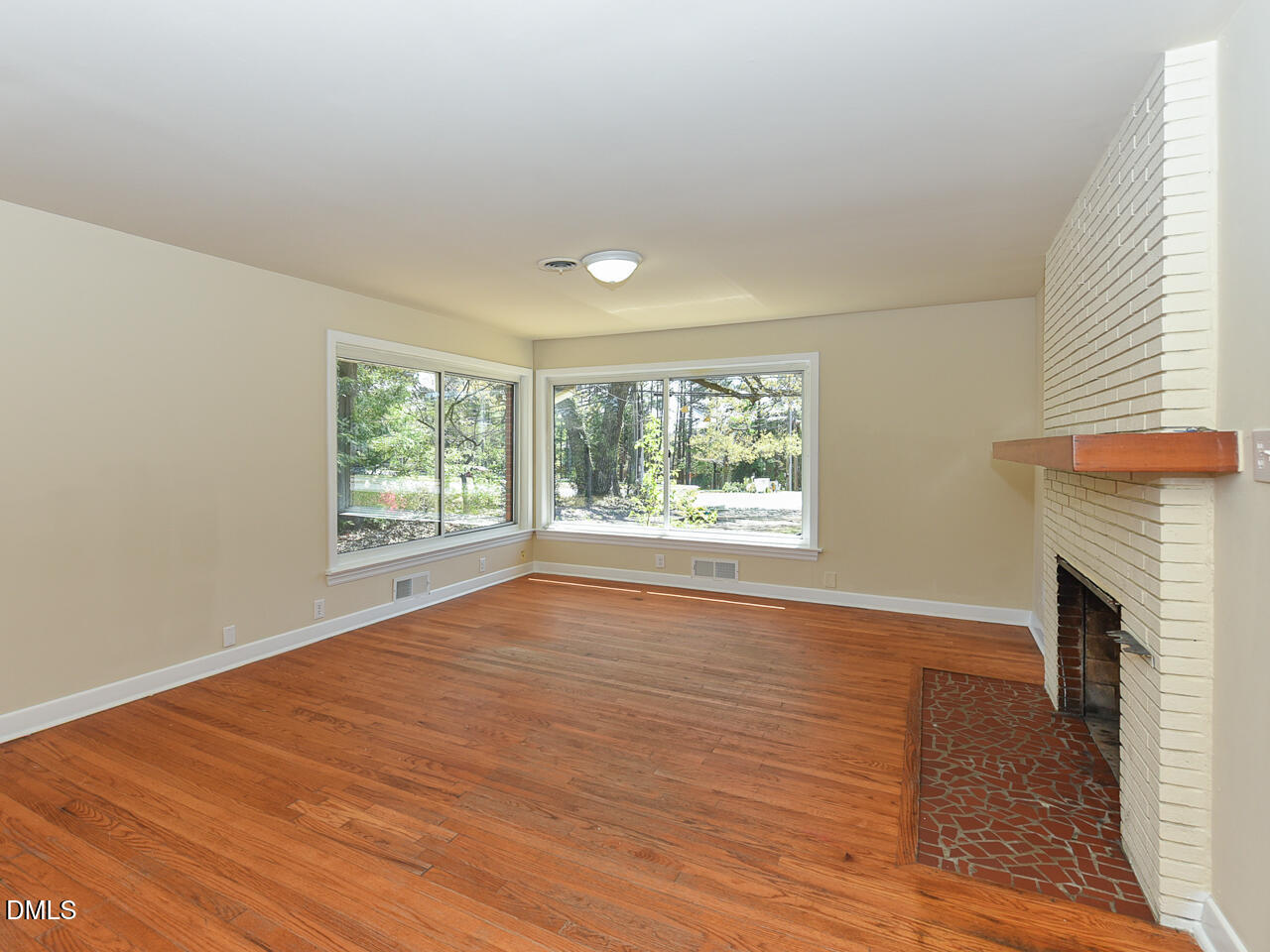 4916 Western Boulevard Raleigh, NC 27606 - Photo 9 of 18 a view of an empty room with wooden floor and a window