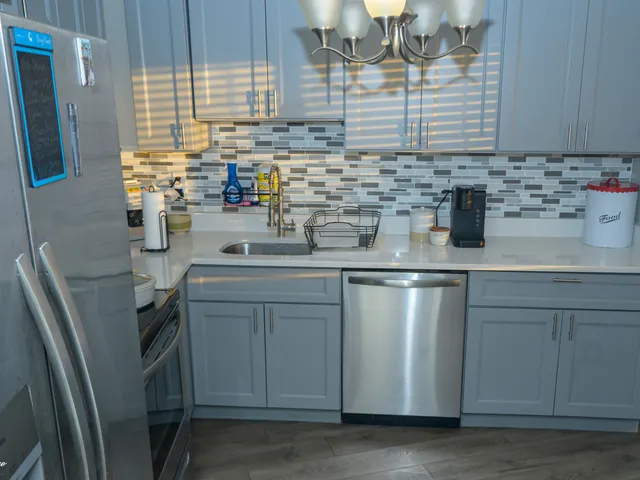 a kitchen with stainless steel appliances a sink stove and cabinets