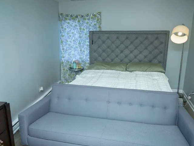 a living room with furniture and a shelf