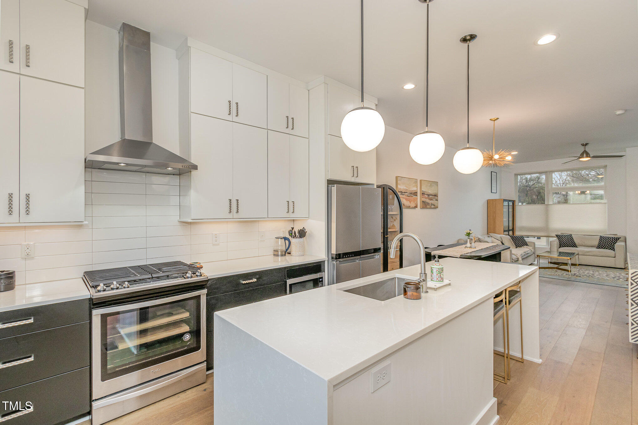 607 North Queen Street Durham, NC 27701 - Photo 3 of 35 a kitchen with kitchen island granite countertop a sink a stove and cabinets