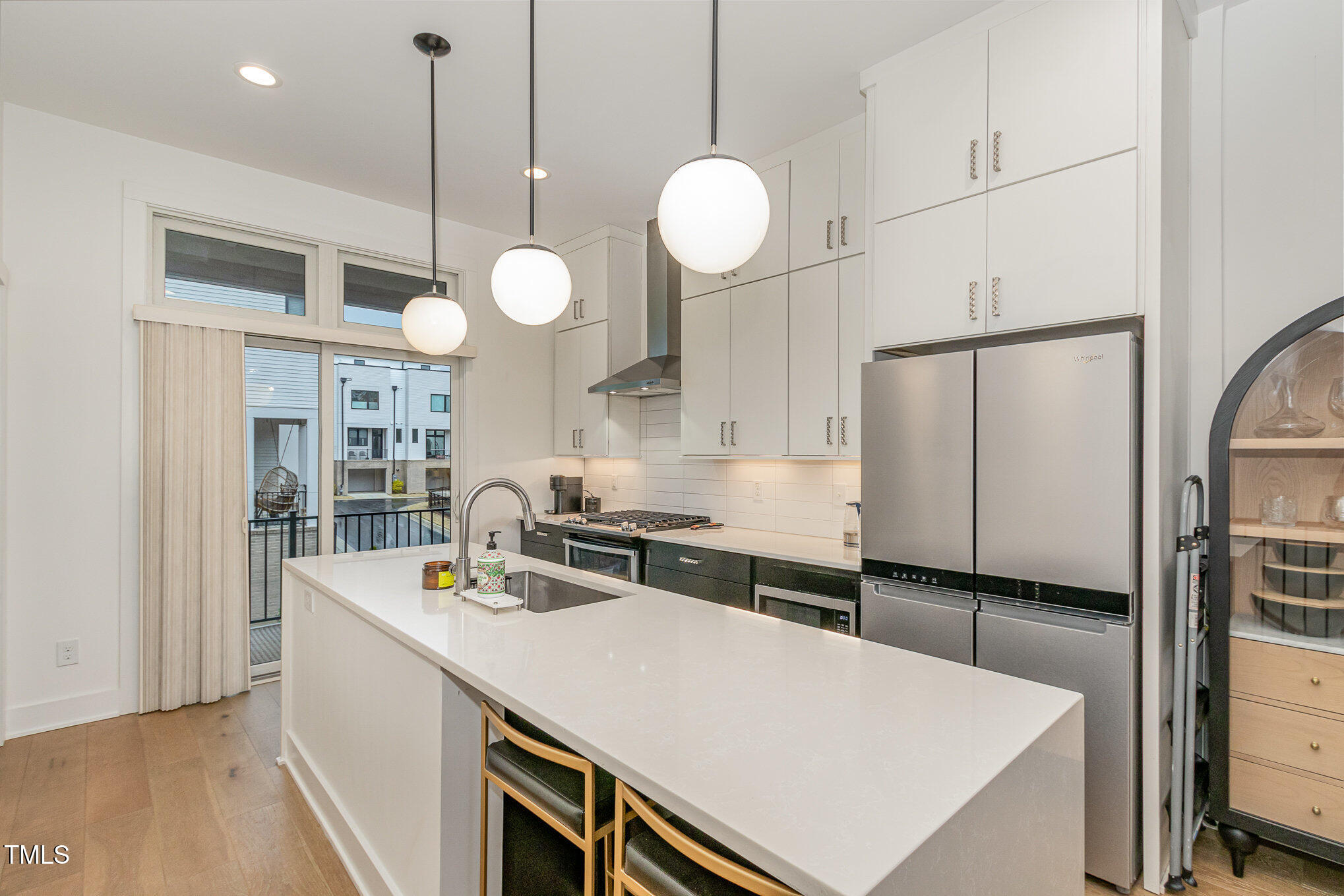 607 North Queen Street Durham, NC 27701 - Photo 9 of 35 a kitchen with a table a sink and cabinets