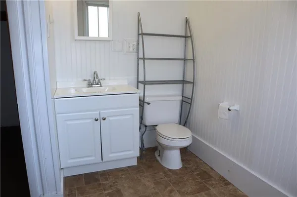 a white toilet sitting next to a bathroom sink