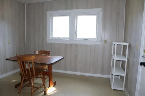 a view of a room that has a table and chair in it