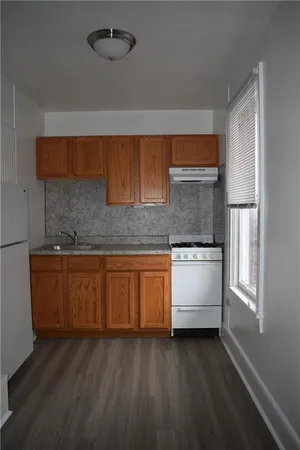 a kitchen with granite countertop white cabinets and white appliances