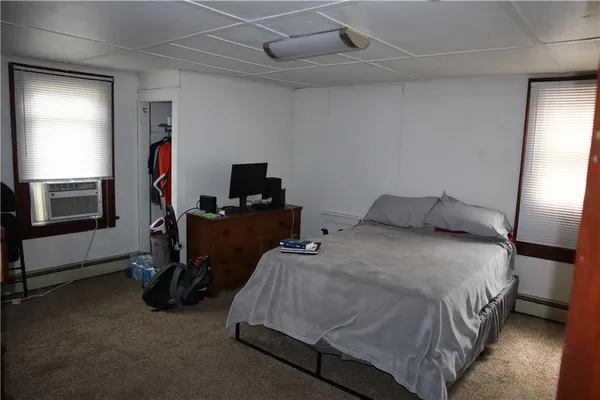 a bedroom with a bed and a tv