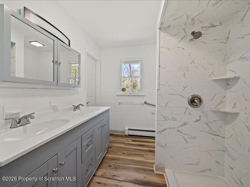 11 Padula Road Tunkhannock, PA 18657 - Photo 16 of 28 a spacious bathroom with a double vanity sink a toilet a mirror and shower