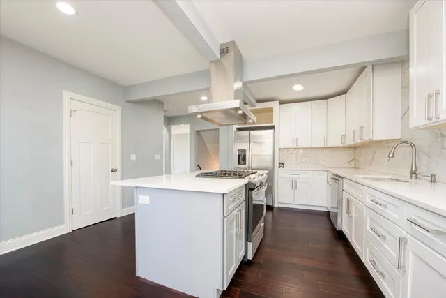 a kitchen with a stove top oven sink and cabinets