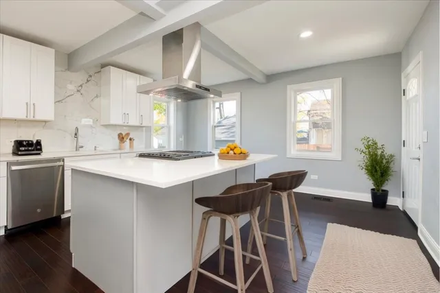 a kitchen with a table chairs sink and cabinets