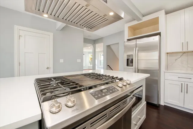 a stove top oven sitting inside of a kitchen