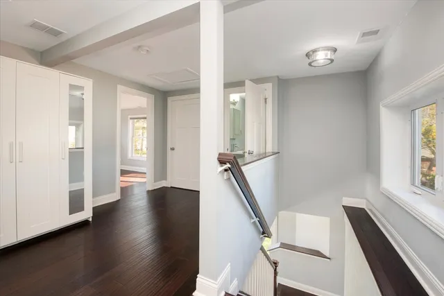 a view of a livingroom with wooden floor and stairs