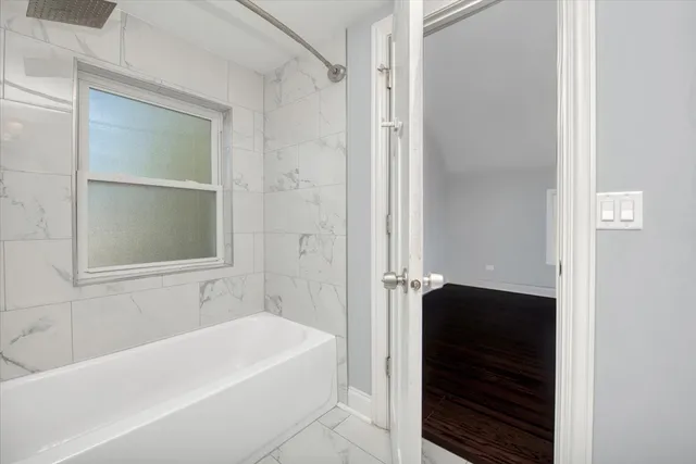 a bathroom with a bathtub and a shower