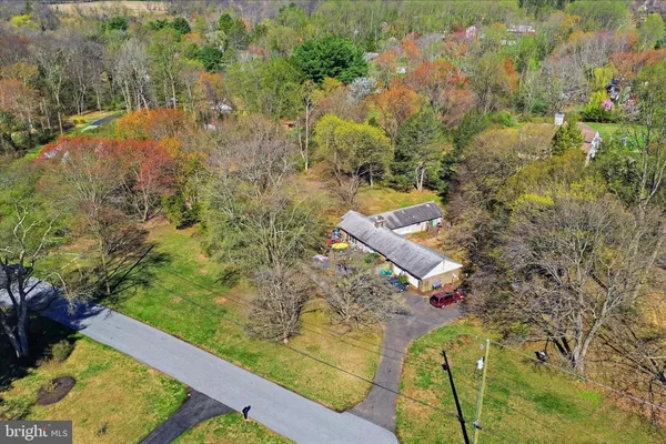 a aerial view of a house with a yard lake and green space