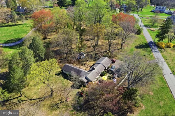 an aerial view of a house with a yard