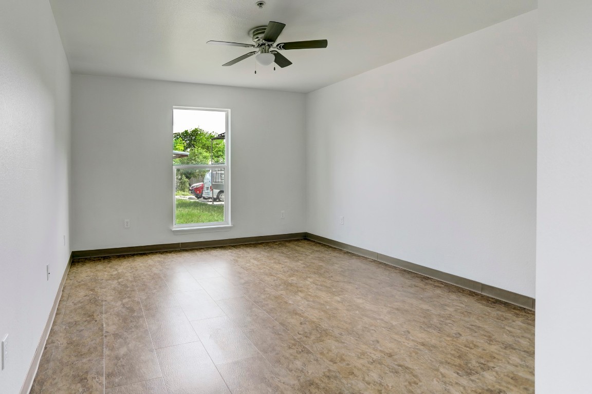 706 West 6th Street, Unit C Taylor, TX 76574 - Photo 8 of 14 Unfurnished room featuring a ceiling fan and baseboards